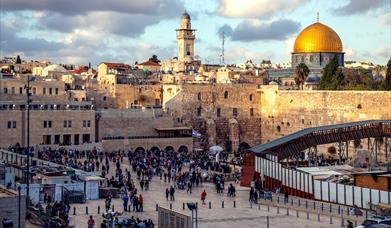 Tourists at the Western Wall and Dome of the Rock in Jerusalem