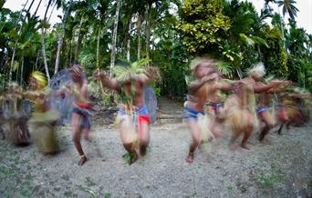 Traditional dancers on South Pacific Island participating in cultural tourism