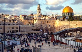 Tourists at the Western Wall and Dome of the Rock in Jerusalem