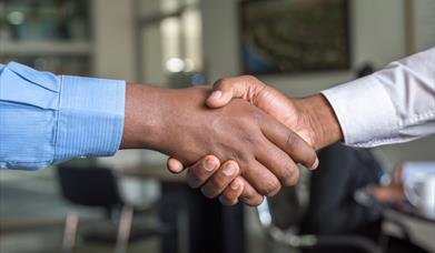 Shaking hands at a business meeting