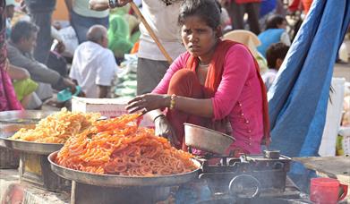 Indian women selling traditional sweets