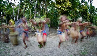 Traditional dancers on South Pacific Island participating in cultural tourism