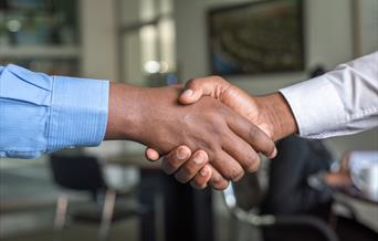 Shaking hands at a business meeting