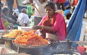 Indian women selling traditional sweets