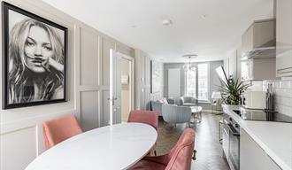 solid marble dining table with chairs at harper luxe apartment