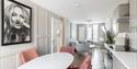 solid marble dining table with chairs at harper luxe apartment