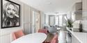 solid marble dining table with chairs at harper luxe apartment