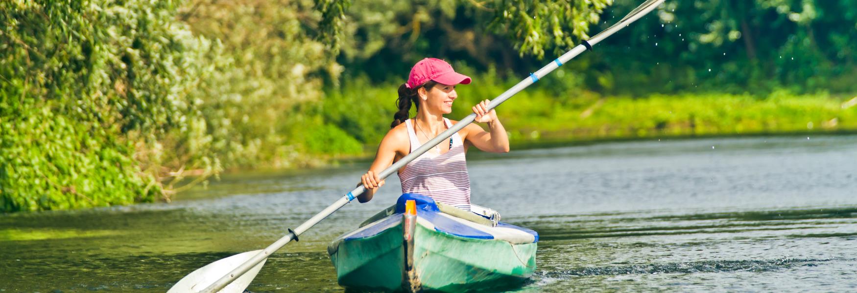 image shows a woman canoeing