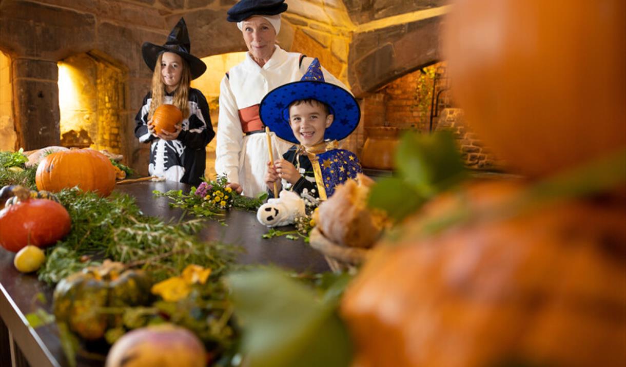 Visitors experiencing Halloween in the Medieval kitchen.