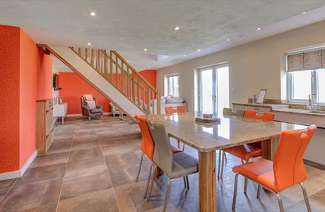 Open living space decorated in orange and white