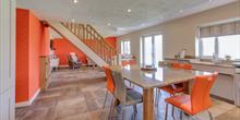 Open living space decorated in orange and white