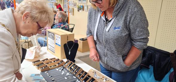 Woman looking at jewelery pop up store