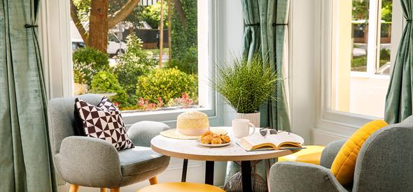 Seating area with yellow and grey modern furniture and views