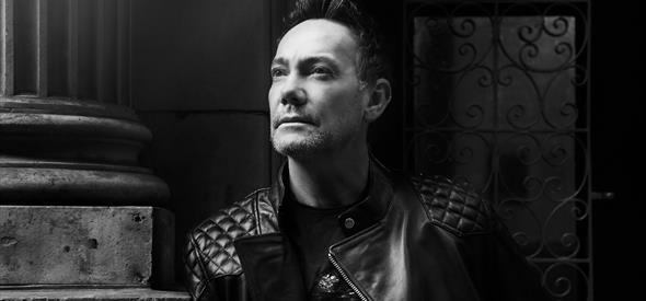 Craig Revel Horwood in black and white looking up 