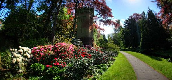 Folly tower surrounded by flora in the gardens 
