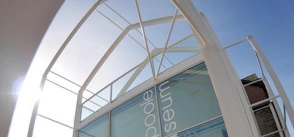 Exterior shot of Poole museum front glass entrance taken from street level