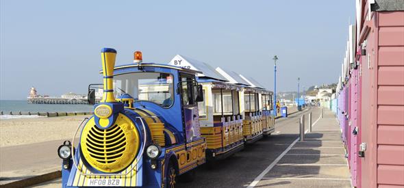 Land training zooming by the colourful beach huts along next the beach