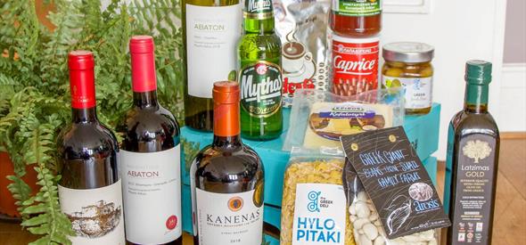 A collection of Greek food, wine and condiments