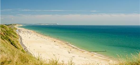 Views of southbourne beach and the blue sea taken from the overcliff on a sunny day