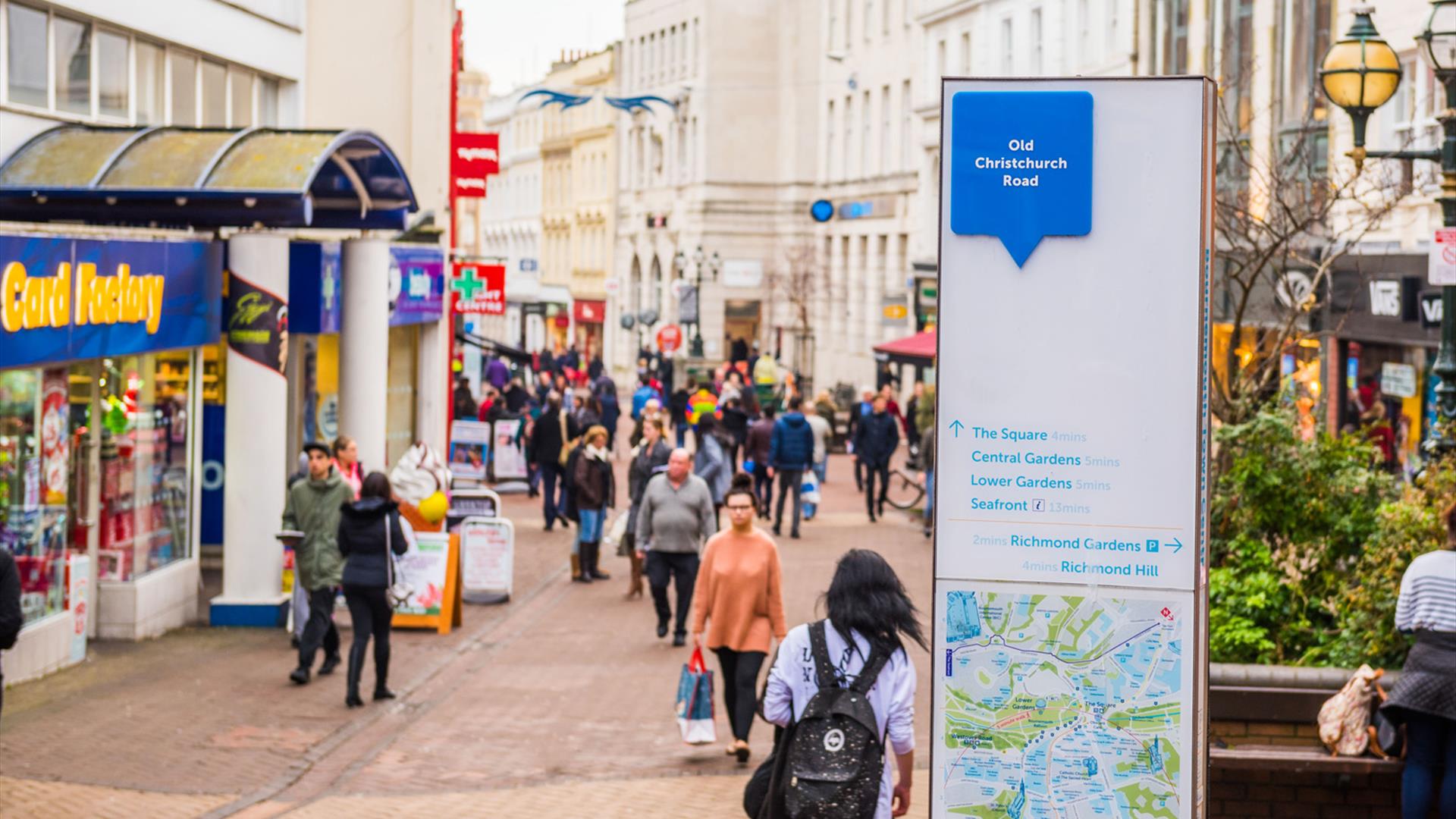 Visitors walking up and down bournemouth high street whilst shopping