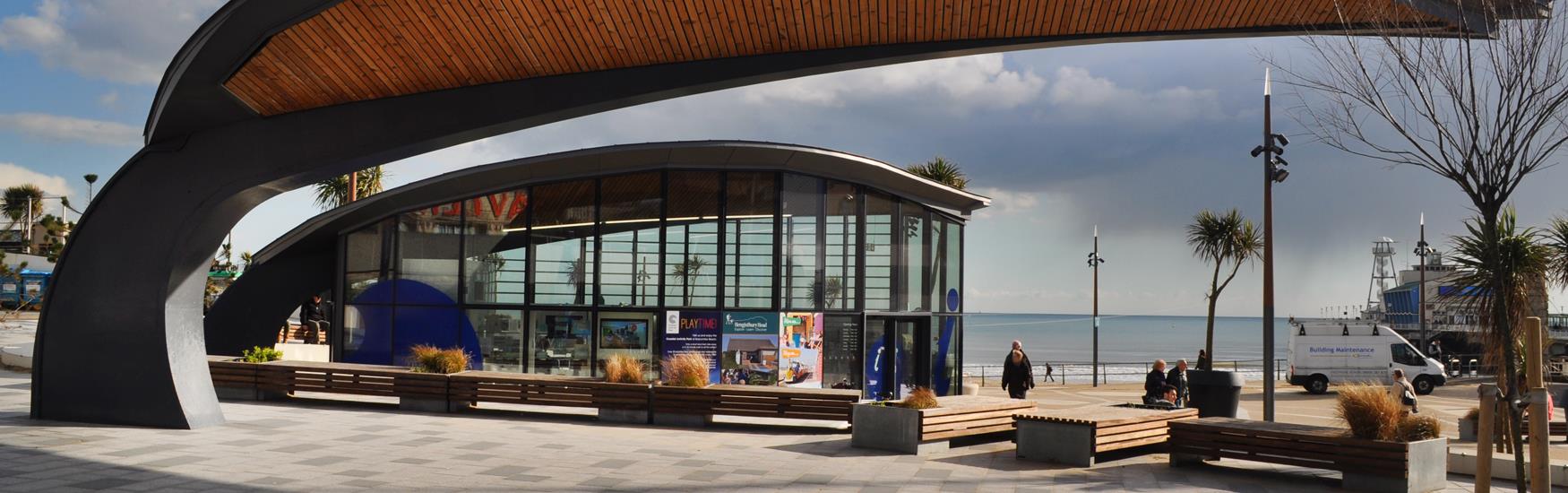 View of Pier Approach area with glass building and the pier and the sea in the background on a summer's day