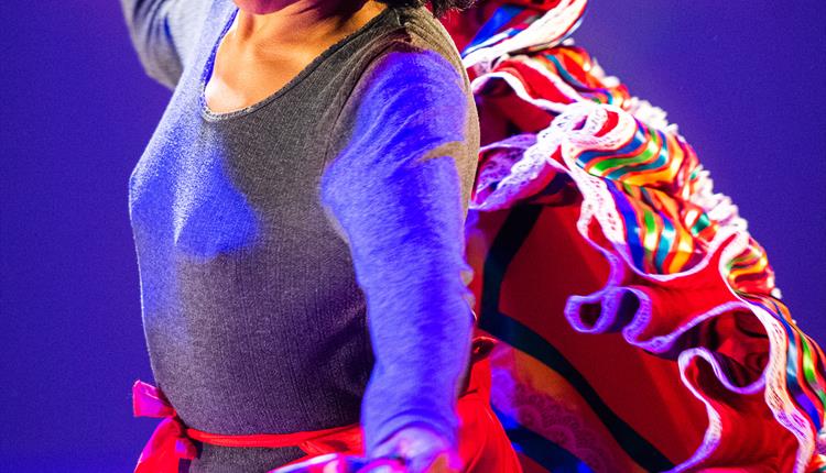 Lady dancing in colourful mexican skirt