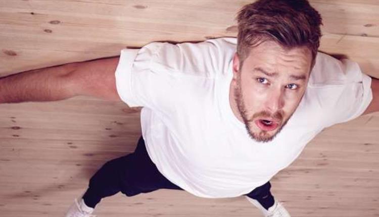 Man in white shirt looking up