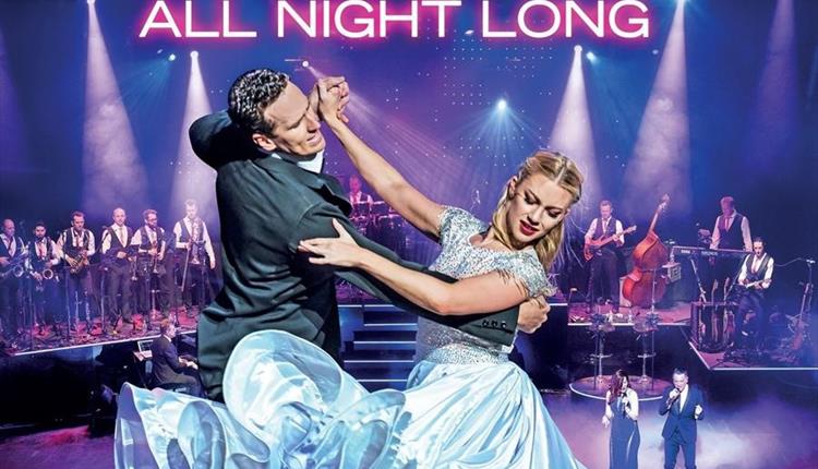 Brendan Cole All Night Long. Brendan dancing with a partner in front of an orchestra.