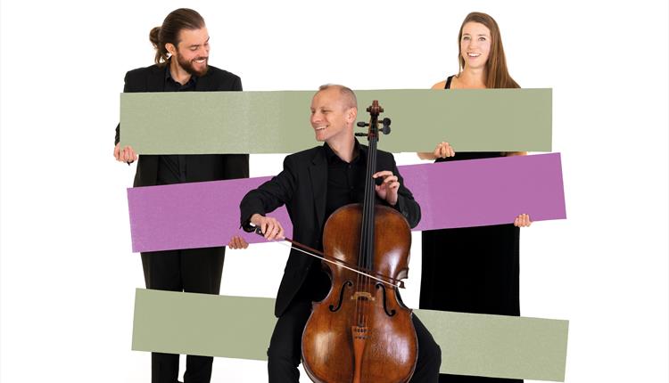 In the foreground a BSO cellist is sat playing, behind him are coloured graphic rectangles, in the background, two other BSO musicians are stood eithe