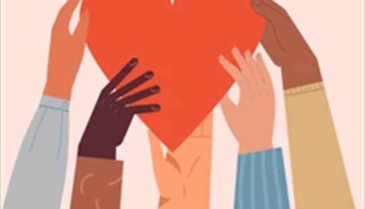 Four hands, different ethnicities holding up a heart