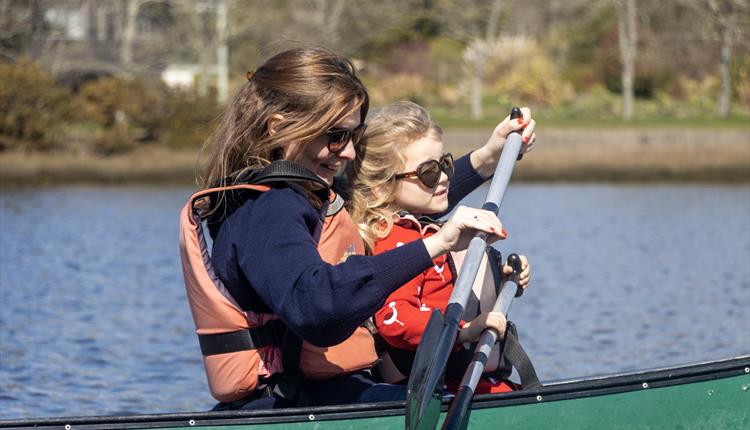 A mum canoeing along the Beaulieu River with her Daughter for Mother's Day