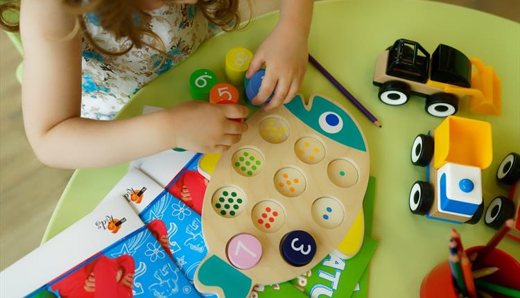 A young child playing games on the floor