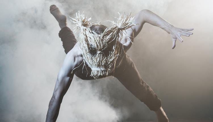 Man in mask surrounded by smoke