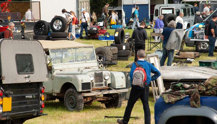 Man looking at old land rover