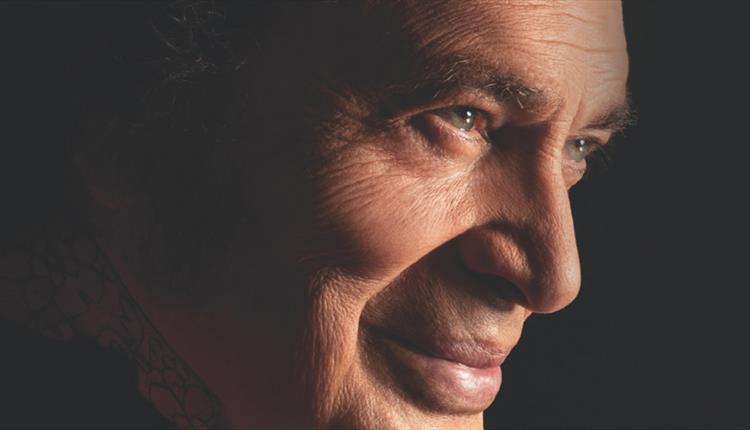 Face of a man close up smiling with black background