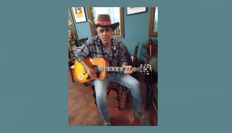 Edward Fox with his guitar