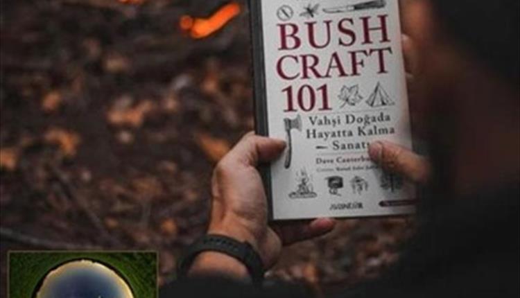 Picture of a man reading a book "Bush craft 101"