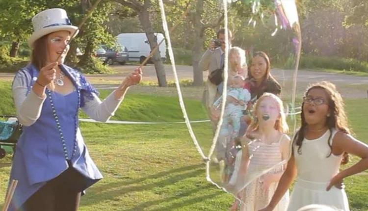 Entertainer performing for kids on grass