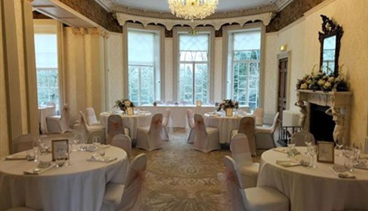 Picture of Upton House Drawing Room with decorated tables and chairs for a wedding