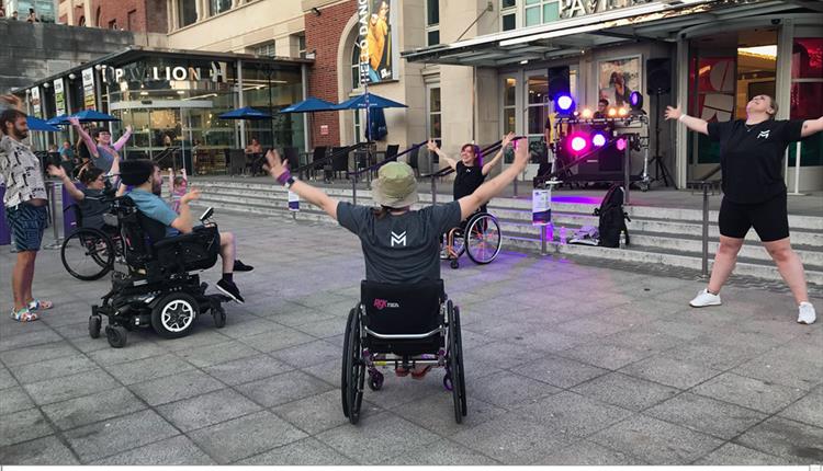 Group of people in wheelchairs dancing.