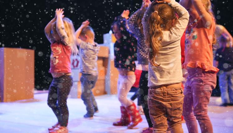 Children dancing in paper snow at the Frozen Dance Workshop