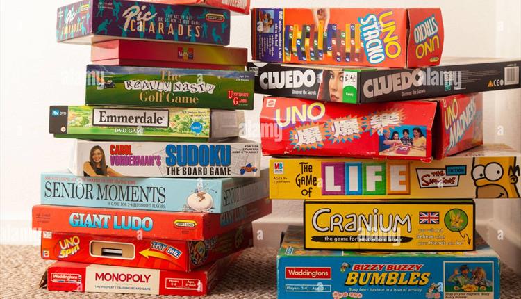two stacks of various boardgames