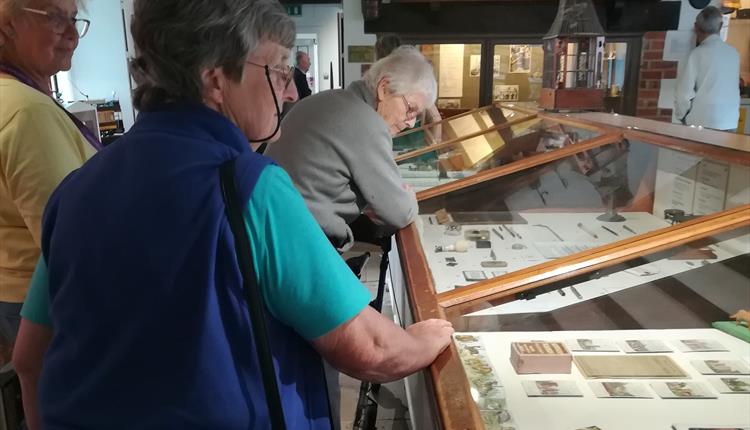 Group of people looking around museum