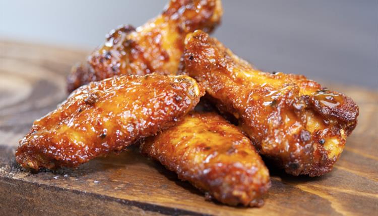 Chicken wings on a wooden board