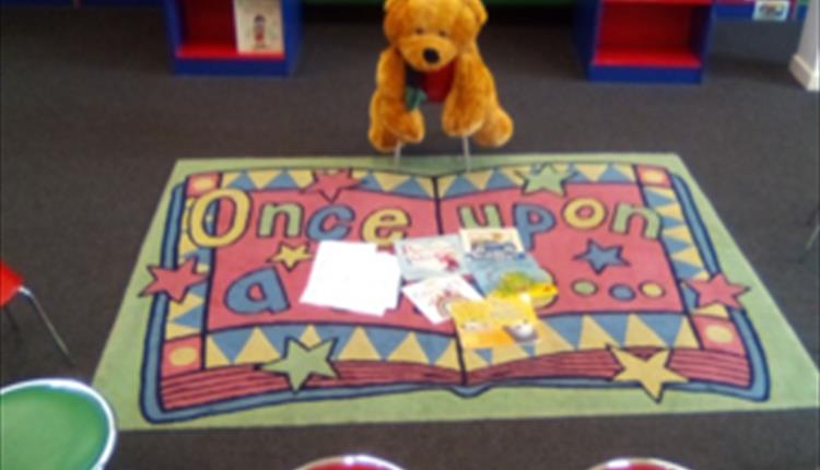 Teddy Bear on chair eagerly awaiting a story.