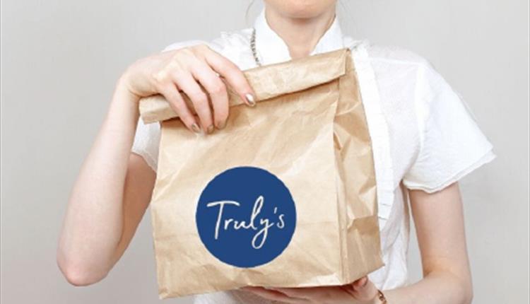 Truly's service in a paper bag