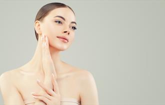 Generic image of woman touching her skin