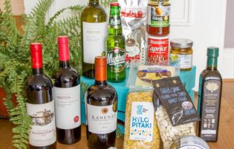 A collection of Greek food, wine and condiments