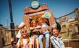 Group of children posing on winners throne after their round of mini golf