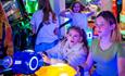 Children playing a game in an arcade